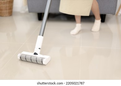 Beautiful Woman Vacuuming The Floor Of Her Living Room, Big Cleaning In The House, Removes Germs And Dirt And Deep Stains, Housewife Cleaning, Keeping Her Home Clean, Domestic Hygiene.