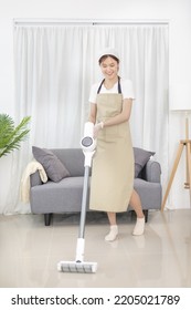 Beautiful Woman Vacuuming The Floor Of Her Living Room, Big Cleaning In The House, Removes Germs And Dirt And Deep Stains, Housewife Cleaning, Keeping Her Home Clean, Domestic Hygiene.