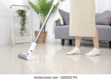 Beautiful Woman Vacuuming The Floor Of Her Living Room, Big Cleaning In The House, Removes Germs And Dirt And Deep Stains, Housewife Cleaning, Keeping Her Home Clean, Domestic Hygiene.