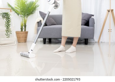 Beautiful Woman Vacuuming The Floor Of Her Living Room, Big Cleaning In The House, Removes Germs And Dirt And Deep Stains, Housewife Cleaning, Keeping Her Home Clean, Domestic Hygiene.