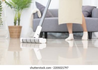 Beautiful Woman Vacuuming The Floor Of Her Living Room, Big Cleaning In The House, Removes Germs And Dirt And Deep Stains, Housewife Cleaning, Keeping Her Home Clean, Domestic Hygiene.