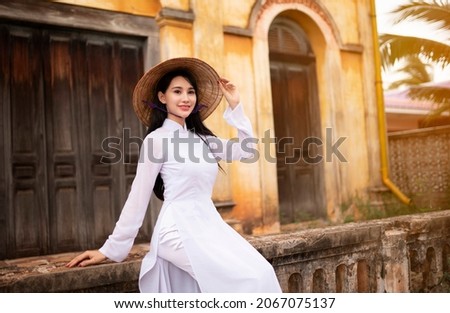 Beautiful woman with Vietnam culture traditional dress, Ao dai, in old resident