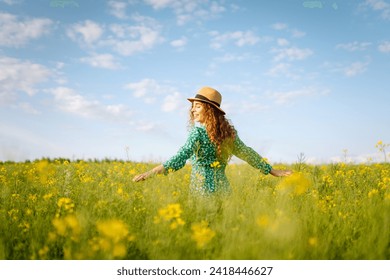 Beautiful woman walking flowering field gently touch yellow flowers. Nature, fashion,  summer lifestyle.  - Powered by Shutterstock