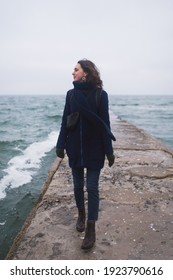 Beautiful Woman Walking On The Beach With Seagulls In Winter Time. Free Spirit Concept