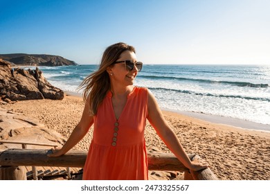 Beautiful woman walking on stairs to sunny beach Portugal, Algarve, Amado praia - Powered by Shutterstock