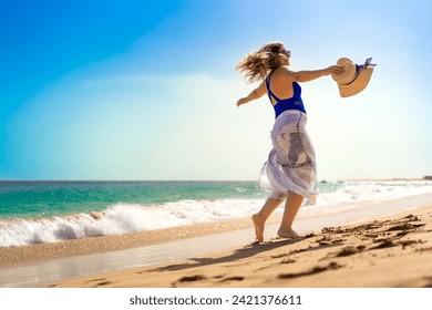 Beautiful woman walking on sunny beach Santa Maria, Sal Island, Cape Verde 