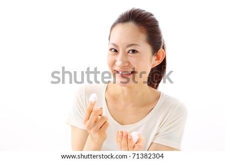 Beautiful woman washing her face with foam on the hands