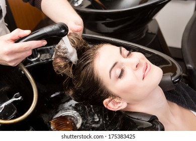 Beautiful woman washing her hair in hairsalon - Shutterstock ID 175383425