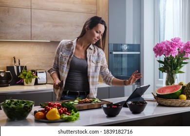 Beautiful Woman Watch Video Recipe While Cooking . - Shutterstock ID 1839182716