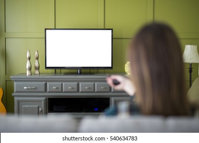 A Beautiful Woman Watching TV Sitting On Couch At Home