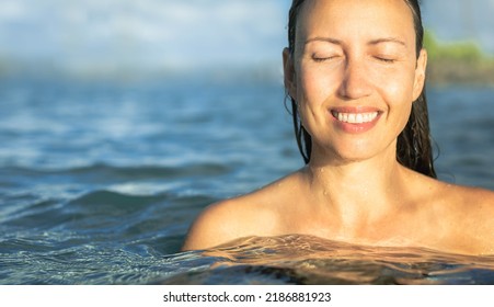 A beautiful woman in the water at the beach. Beauty spa nature concept. Skin care.