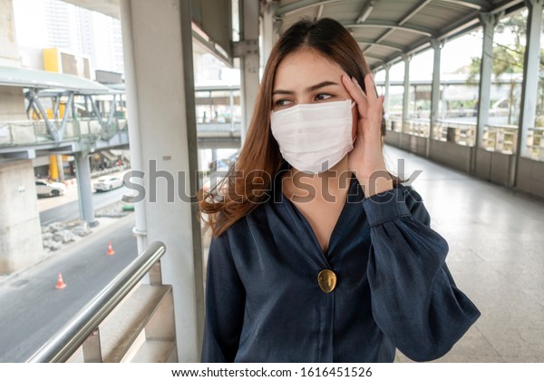 Beautiful woman wearing anti dust mask
protect air pollution and pm 2.5 on street
city