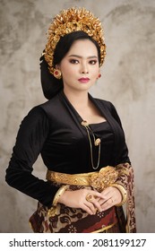 Beautiful woman wearing Balinese Kebaya with patterned wall background