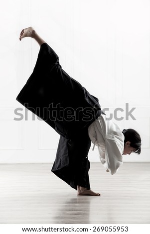 beautiful woman wearing a hakama engaged in Jiu Jitsu 