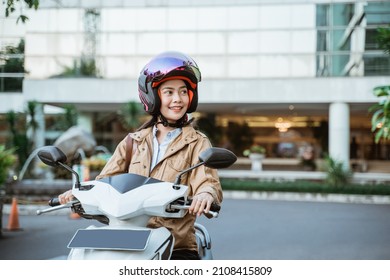 Beautiful Woman Wearing A Helmet While Riding A Motorcycle