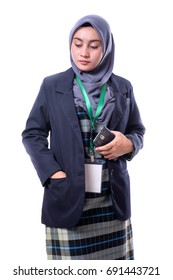 Beautiful  Woman Wearing Hijab, Suit And Wearing A Blank ID Tag Or Name Card On A Lanyard  Holding Cellphone And Smiling. Isolated On White Background .