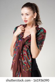 beautiful woman wearing kashmir scarf isolated on grey