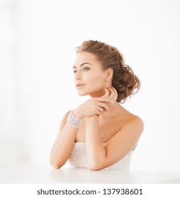 Beautiful Woman Wearing Pearl Earrings And Bracelet