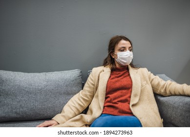 Beautiful woman wearing protective medical mask and fashionable clothes rests in chair.New normal concept. - Powered by Shutterstock