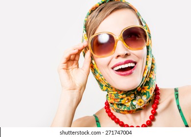 Beautiful woman wearing scarf and sunglasses over white background