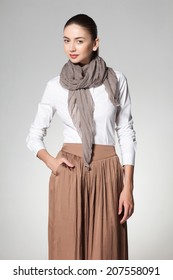 beautiful woman wearing a scarve on grey background