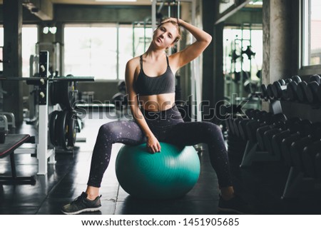 Similar – Image, Stock Photo young woman foam rolling after exercise in gym