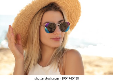 Beautiful woman wearing sunglasses outdoors on sunny day