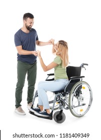 Beautiful Woman In Wheelchair With Man Dancing On White Background