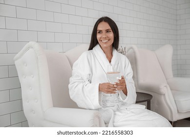 Beautiful Woman In White Bathrobe Drink Water During Medical Procedure In Beauty Clinic