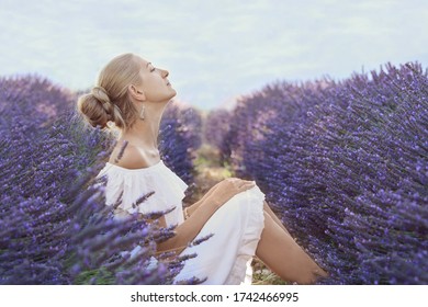 Beautiful Woman In A White Dress On A Lavender Field In Provence, France