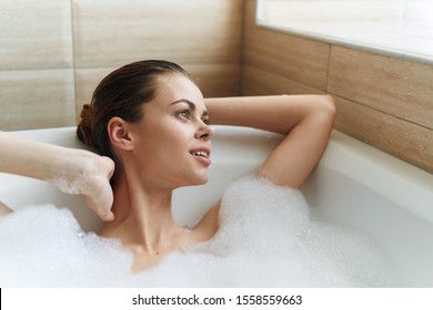 Beautiful woman white foam window rest bathroom