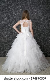 Beautiful Woman In White Wedding Dress With Corset.  Back View