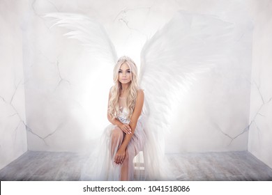 beautiful woman with white wings on white background