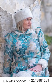 A Beautiful Woman In A Winter Coat And Winter Hat (Ushanka). A Beautiful Woman In An Abandoned Castle.
