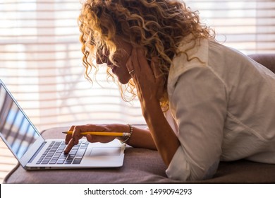 Beautiful Woman Working At Home On The Sofa Or Watching Video Or Playing - Adult With Pencil Looking At Her Laptop Or Computer Pc Still Work To Be A Rich Woman In The Future