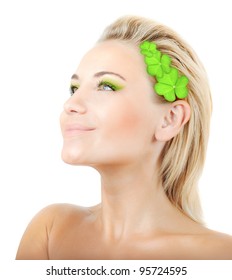 Beautiful woman with wreath of clover, fresh green plant leaves in blond hair, female face portrait isolated over white background, pretty girl with bright makeup, st. Patrick's day, spring holiday