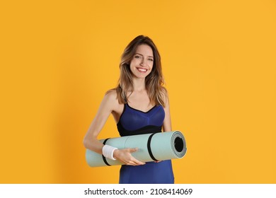 Beautiful Woman With Yoga Mat On Yellow Background