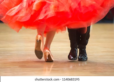 Beautiful womanish and masculine legs in active ballroom dance, indoors