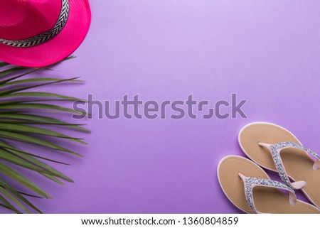 beautiful woman's beach flip-flops on the violet or purple background with copy space. beach summer concept and holiday concept flat lay