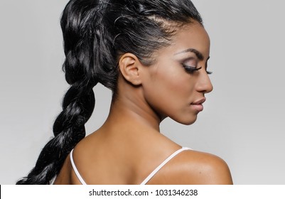 Beautiful Woman's Face In Profile, Hair Braided; Isolated Against Light Grey Background.