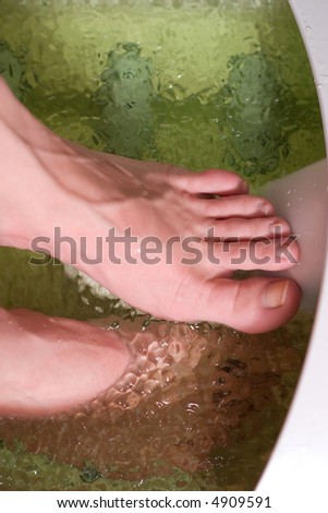beautiful woman's foot relaxing in the water