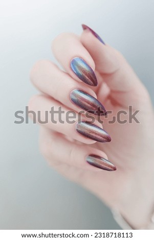 Beautiful woman's hand with long nails and multicolored nail polish