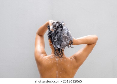 Beautiful woman's hand She was washing her hair and nourishing her scalp. Shampoo and conditioner