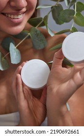 Beautiful Woman's Hands Holding White Squeeze Bottle Plastic Tube W Spring Flowers On White Background. Packaging Of Skincare Products Cream, Lotion, Gel, Foam For Natural Beauty Cosmetic Concept.