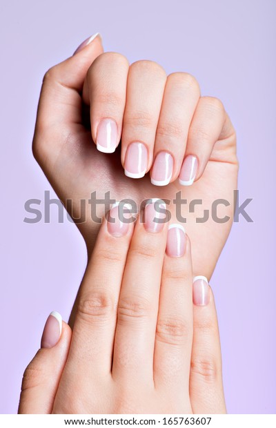 Beautiful woman\'s hands with beautiful \
nails after manicure salon with french\
manicure