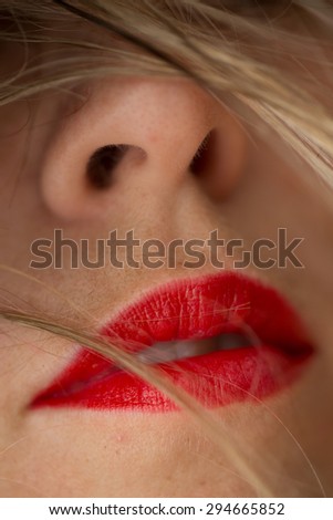 Beautiful woman's red lips and blonde hair