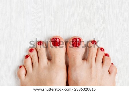 Beautiful woman's vinous burgundy nails with beautiful pedicure. Female feet with bright pedicure on white wooden background. Autumn and winter concept. Top view, copy space, horizontal, close up [[stock_photo]] © 