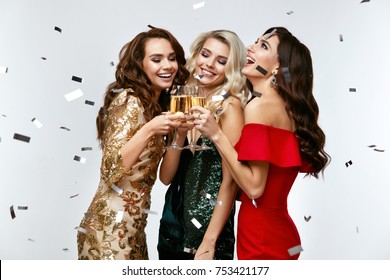 Beautiful Women Celebrating New Year, Having Fun At Party. Portrait Of Happy Smiling Girls In Stylish Glamorous Dresses With Champagne Glasses At Fashion Party. High Resolution.