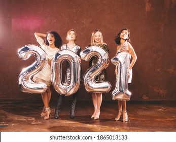 Beautiful Women Celebrating New Year.Happy Gorgeous Female In Stylish Sexy Party Dresses Holding Silver 2021 Balloons, Having Fun At New Year's Eve Party. Holiday Celebration.Charming Models  - Shutterstock ID 1865013133