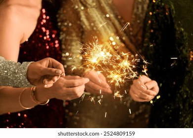 Beautiful women with Christmas sparklers at Christmas party, closeup - Powered by Shutterstock